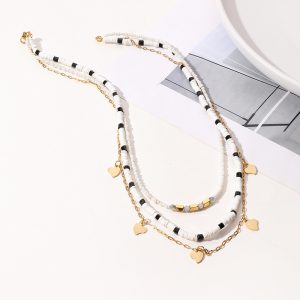 layered black & white beaded necklace with 14k gold plated heart charms