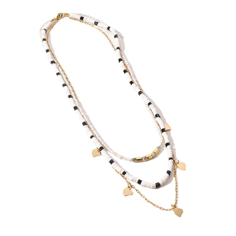 layered black & white beaded necklace with 14k gold plated heart charms layered black & white beaded necklace with 14k gold plated heart charms