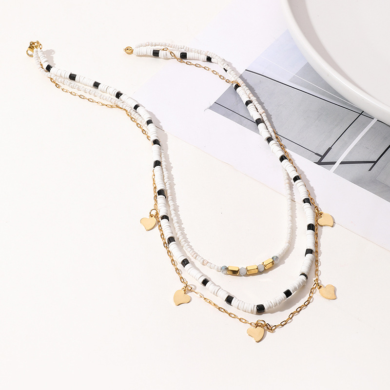 layered black & white beaded necklace with 14k gold plated heart charms layered black & white beaded necklace with 14k gold plated heart charms